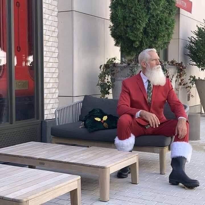 Stylish Santa poses on a bench
