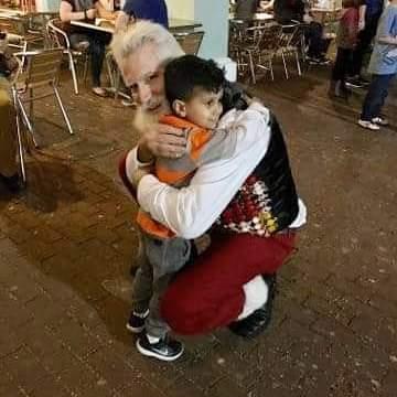 Santa hugs child